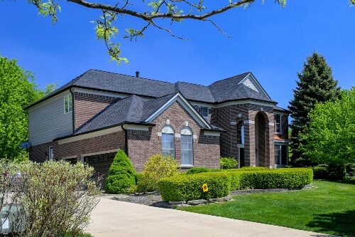 A beautiful home with well-maintained roof during springtime