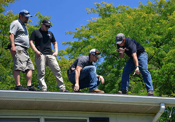 Sherriff Goslin Roofing professionals on roof for work
