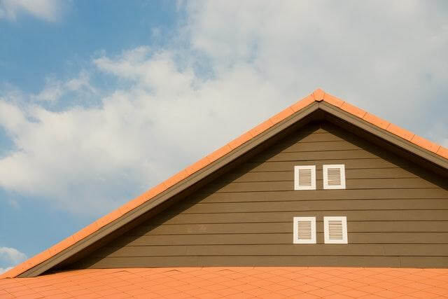 An orange-roofed home has a well-maintained roof that will protect its home for years to come.